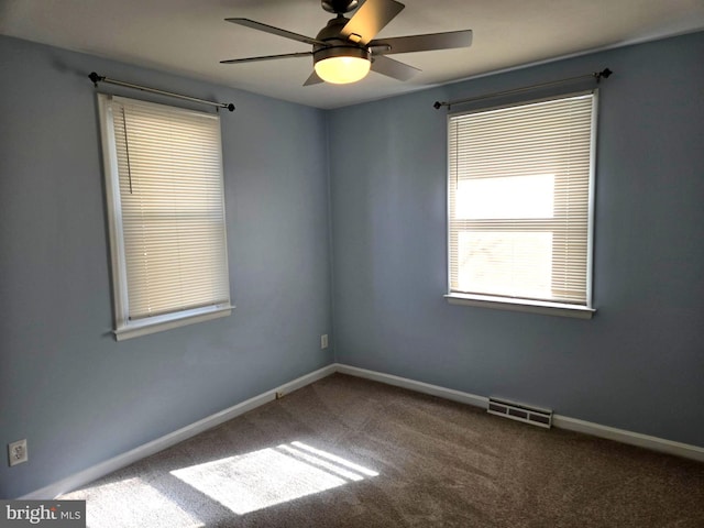 carpeted spare room with ceiling fan