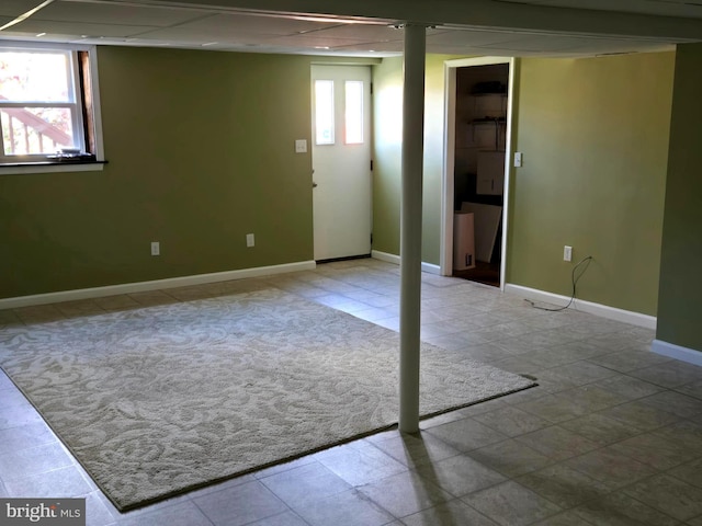 basement with a paneled ceiling