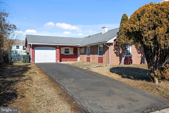 ranch-style home featuring a garage and a front yard