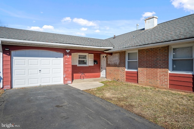 view of front of home featuring a garage and a front lawn