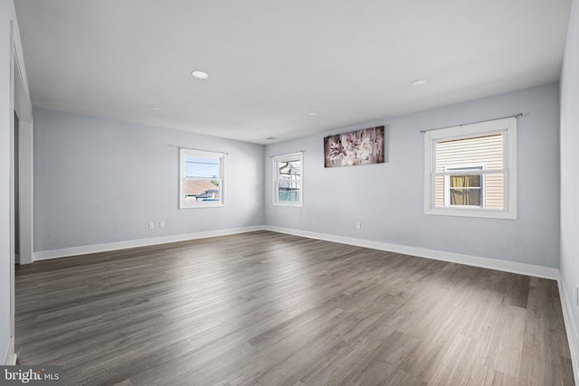 spare room with dark hardwood / wood-style floors