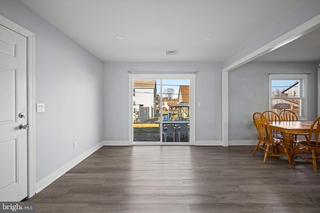 dining area with dark hardwood / wood-style flooring and a healthy amount of sunlight