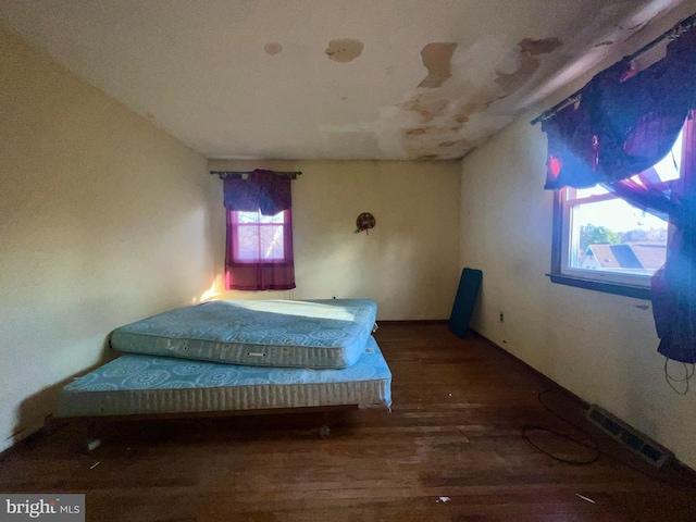 bedroom with hardwood / wood-style flooring