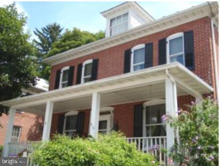 back of property with covered porch