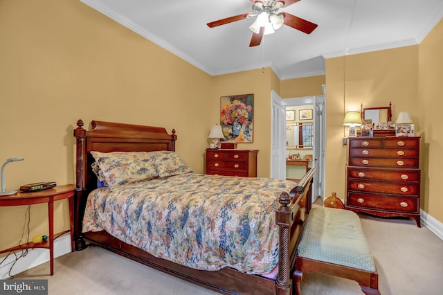 carpeted bedroom featuring ornamental molding and ceiling fan