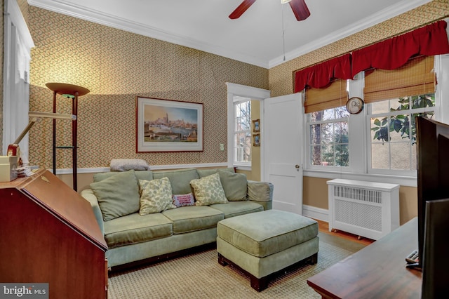 living room with ornamental molding, radiator, and ceiling fan