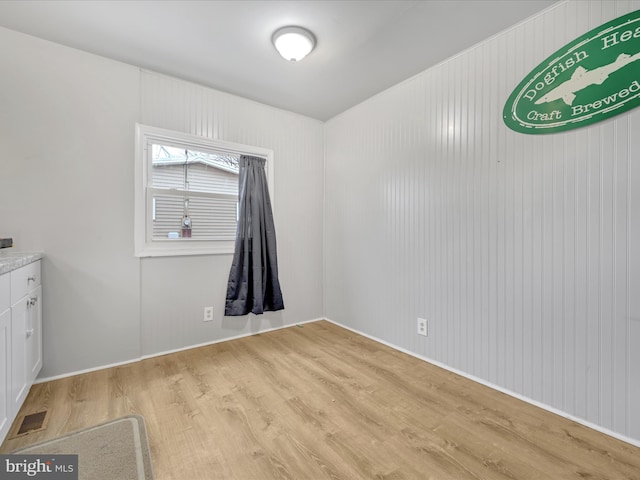 empty room with light hardwood / wood-style flooring