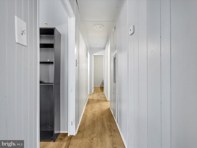 corridor with light hardwood / wood-style floors