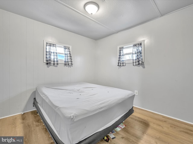 bedroom with hardwood / wood-style floors