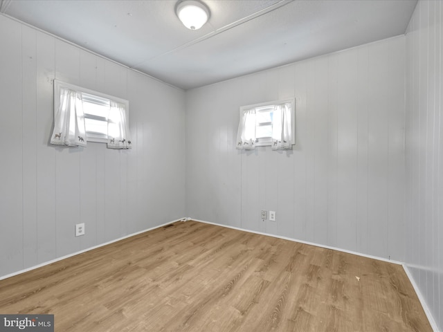 empty room with light hardwood / wood-style floors