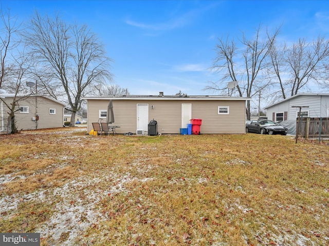 back of property featuring a lawn