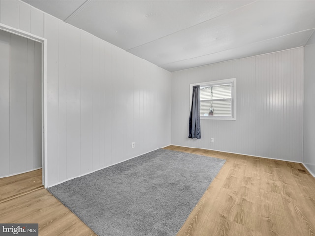 spare room featuring wood-type flooring