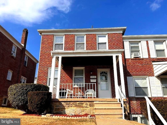 view of front of home featuring cooling unit and a porch