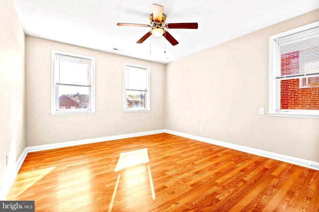 unfurnished room with hardwood / wood-style flooring and ceiling fan