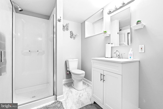 bathroom featuring vanity, toilet, and a shower with door