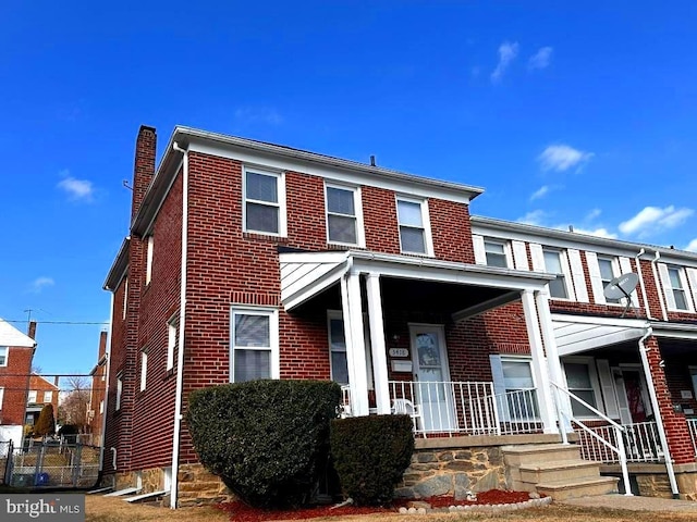 townhome / multi-family property featuring covered porch