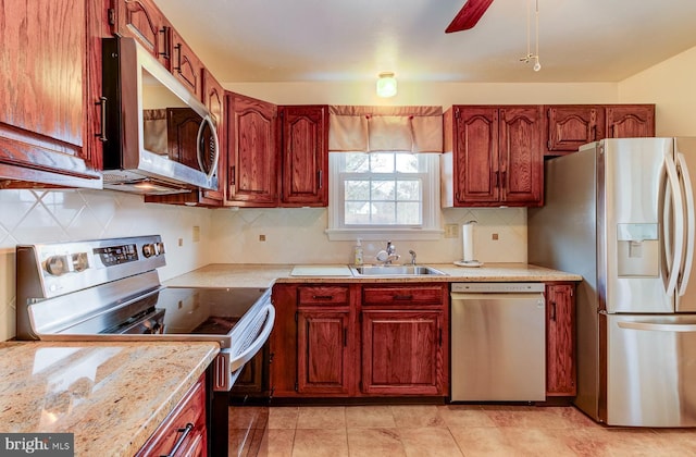 kitchen with tasteful backsplash, sink, light tile patterned floors, ceiling fan, and stainless steel appliances