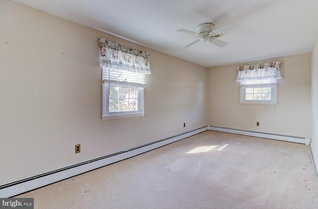 empty room with light colored carpet, ceiling fan, and baseboard heating