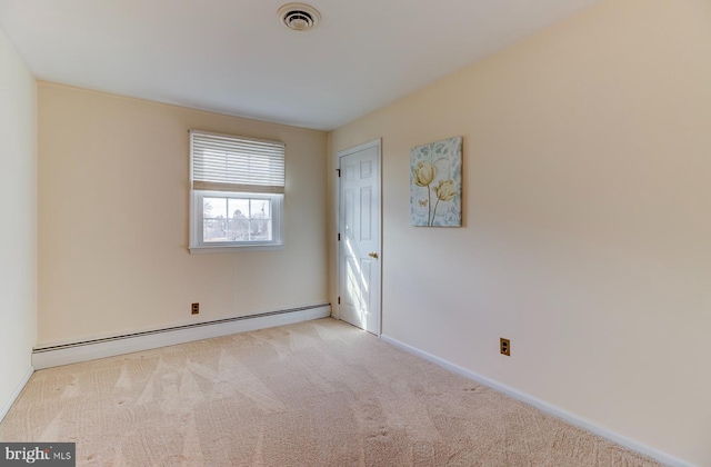 spare room with a baseboard radiator and light colored carpet