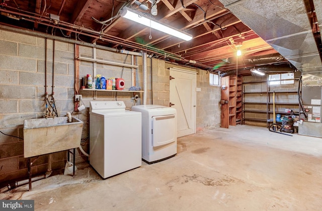 basement with separate washer and dryer and sink