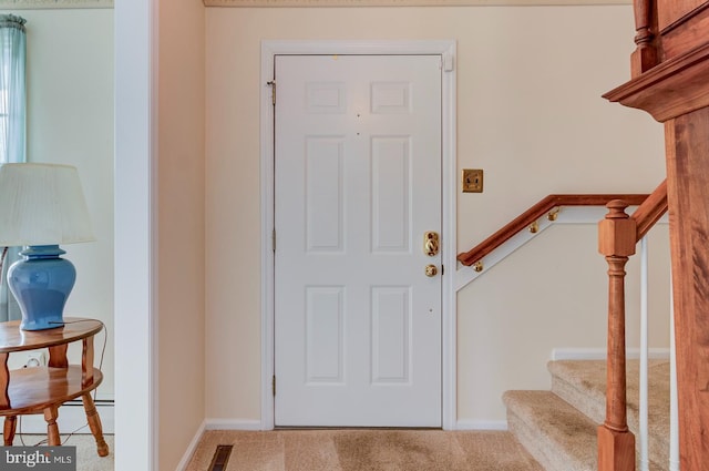 view of carpeted entrance foyer