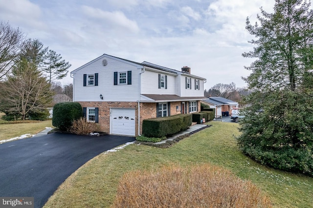 view of front of house with a garage and a front lawn