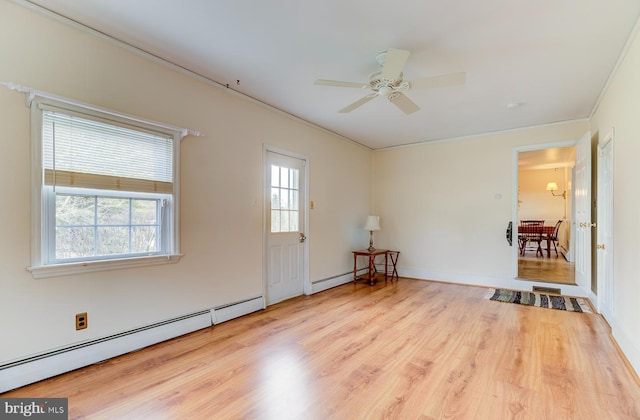 empty room with a baseboard radiator, ceiling fan, and light hardwood / wood-style floors