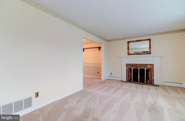 unfurnished living room with a baseboard heating unit, crown molding, a fireplace, and light colored carpet