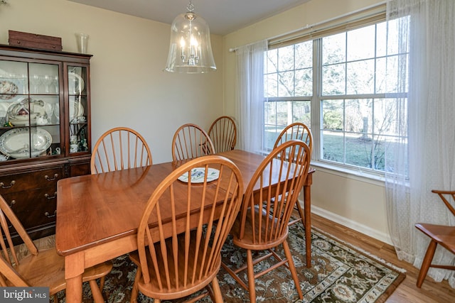 dining room featuring a wealth of natural light, a chandelier, and light hardwood / wood-style flooring