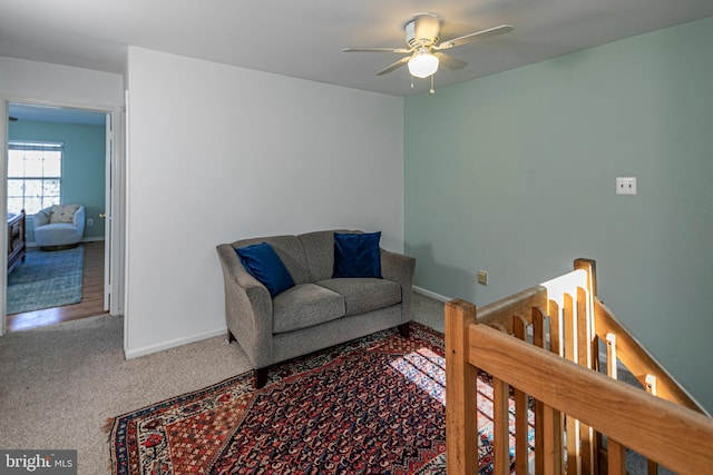 interior space featuring ceiling fan and carpet