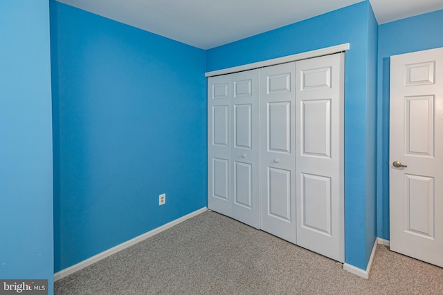 unfurnished bedroom featuring a closet and carpet