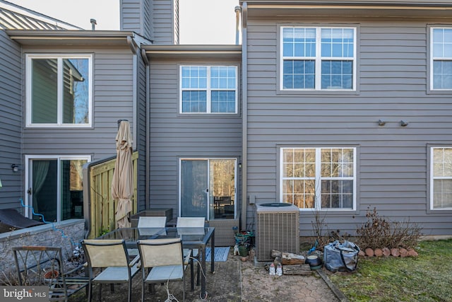 rear view of property featuring a patio and central air condition unit