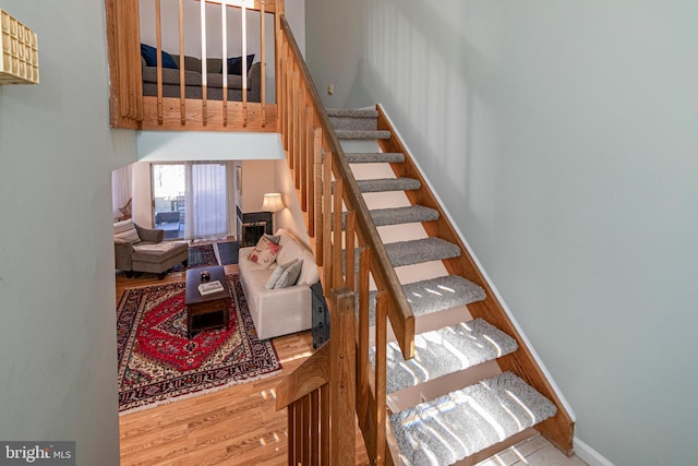 stairs featuring hardwood / wood-style floors