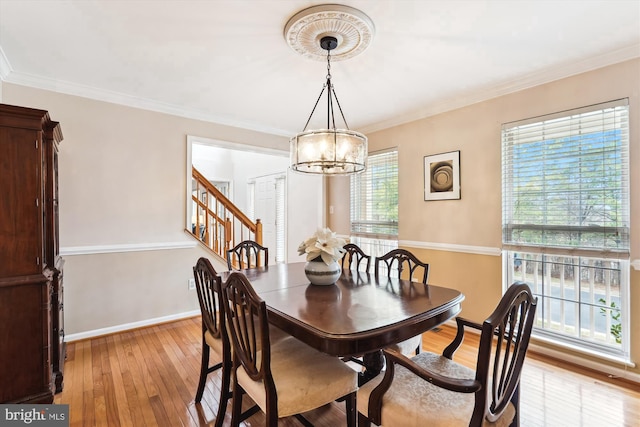 dining area with crown molding, baseboards, a chandelier, stairway, and light wood-style floors