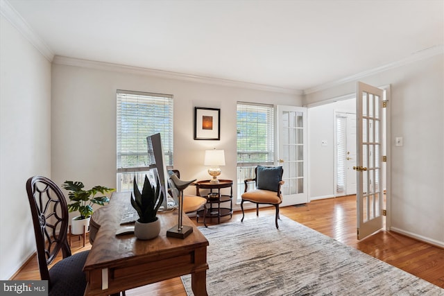 home office with baseboards, a healthy amount of sunlight, wood finished floors, and ornamental molding