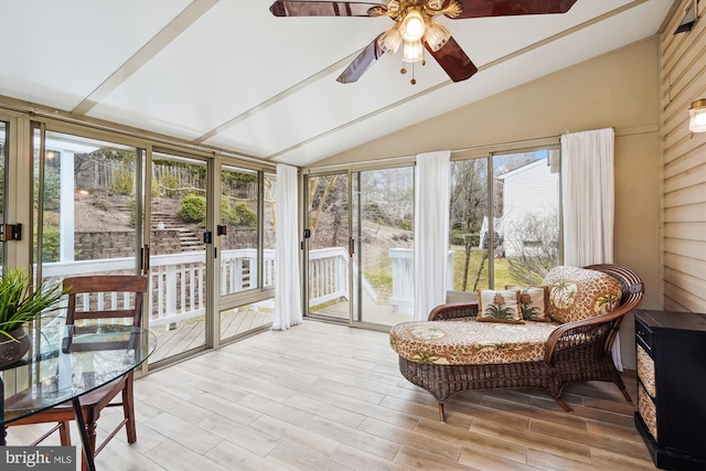 sunroom / solarium with a ceiling fan and vaulted ceiling