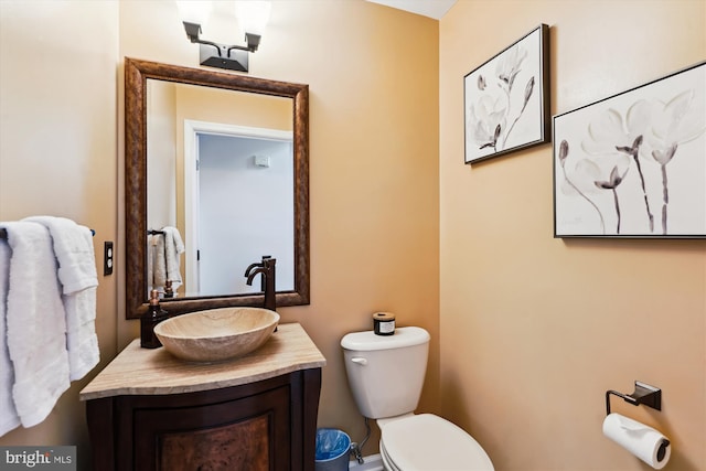 bathroom with toilet and vanity