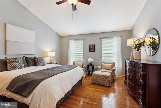 bedroom featuring ceiling fan, lofted ceiling, and wood-type flooring