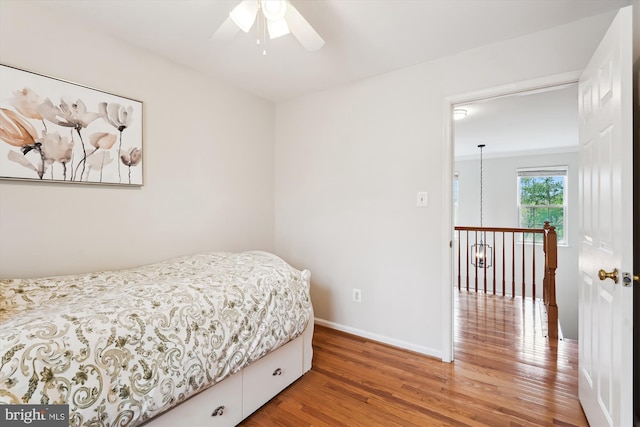 bedroom with light wood finished floors and baseboards