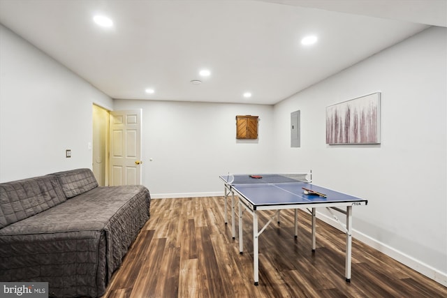 recreation room featuring electric panel, recessed lighting, wood finished floors, and baseboards