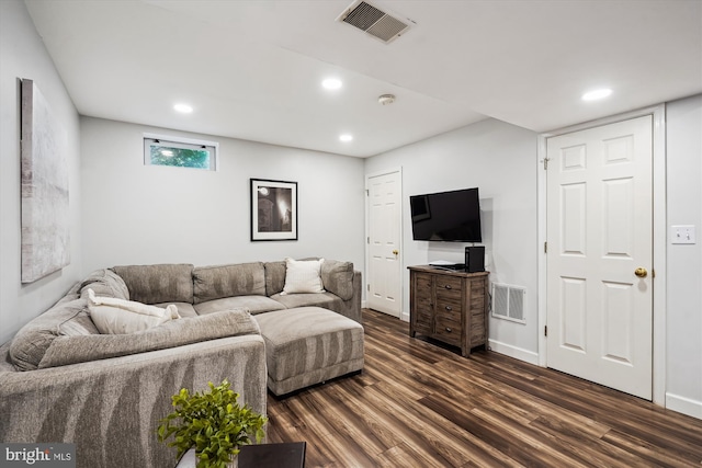 living room with recessed lighting, visible vents, and dark wood-type flooring