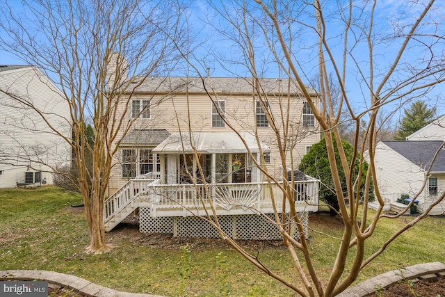 rear view of house featuring a wooden deck, a lawn, and a chimney