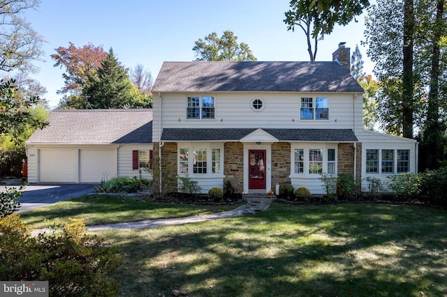 view of front of house with a garage and a front yard