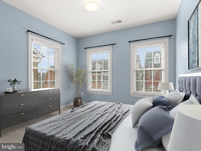 bedroom with multiple windows and carpet flooring