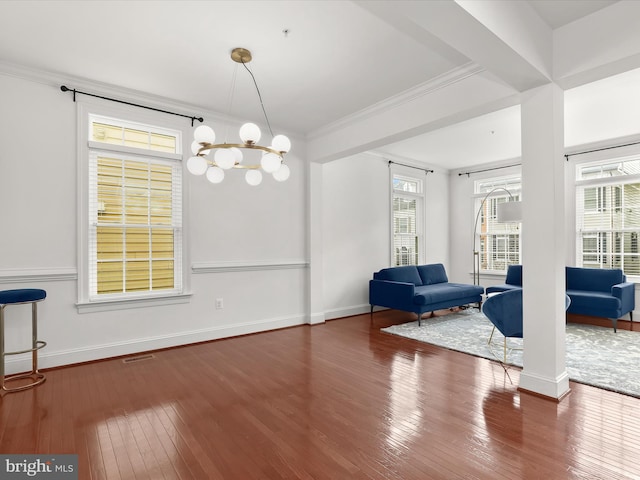 interior space featuring crown molding, dark hardwood / wood-style floors, and a chandelier