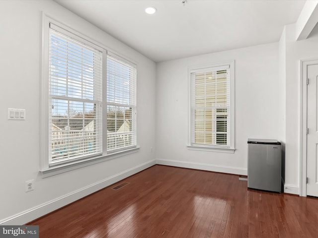 unfurnished room with dark hardwood / wood-style floors