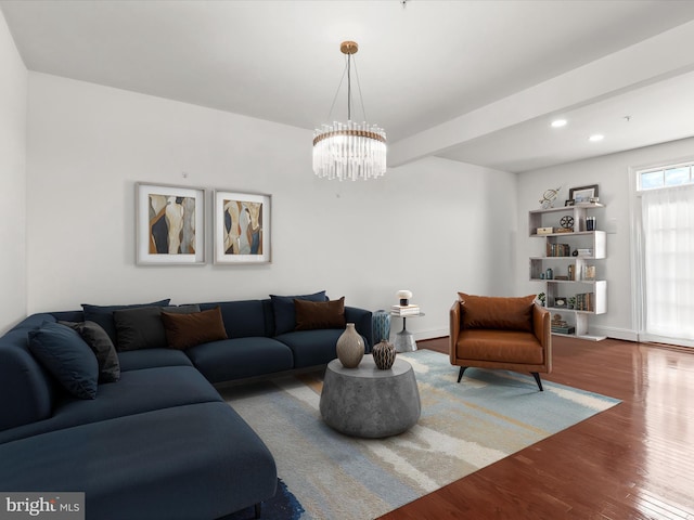 living room featuring an inviting chandelier and wood-type flooring