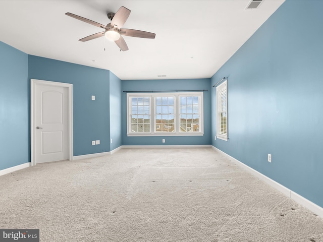 unfurnished room with light colored carpet and ceiling fan