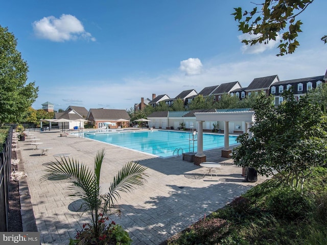 view of swimming pool with a pergola and a patio