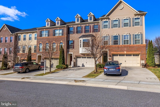 view of property featuring a garage, brick siding, and driveway